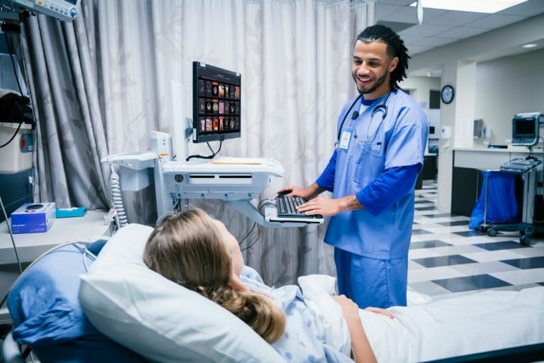 A doctor and a patient having a conversation while using VisualDx